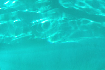 Trendy blue colored abstract background with light and shadows caustic effect. Light passes through a glass.