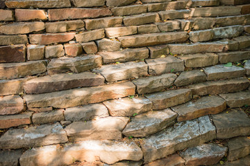 decorative staircase. a stone staircase rises to the mountain slope covered with fallen leaves in autumn