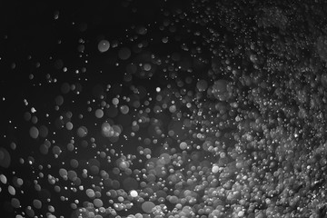 White bokeh background in darkness, Water droplets that affect light