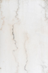 texture of white limestone with dark streaks. Very beautiful background. Abstract pattern for the screen.