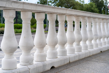 white palace railings with blown props. Beautiful classical architecture. Luxury street railings.