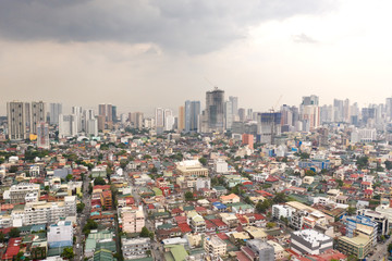 Fototapeta na wymiar Residential areas and streets of Manila, Philippines, top view. Roofs of houses and roads. Philippine capital.