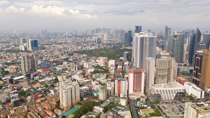 Fototapeta na wymiar Modern city. The city of Manila, the capital of the Philippines. Modern metropolis in the morning, top view. Modern buildings in the city center.