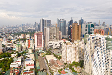 Fototapeta premium The city of Manila, the capital of the Philippines. Modern metropolis in the morning, top view. New buildings in the city. Panorama of Manila. Skyscrapers and business centers in a big city.