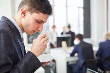 Student drinks cup of coffee