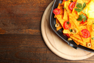 Corn chips nachos with cherry and olives