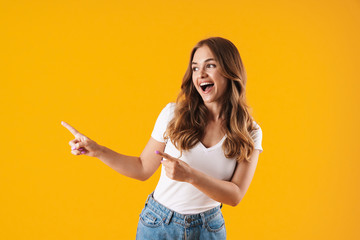 Excited young girl wearing casual clothes standing