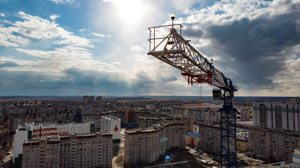 Fototapeta na wymiar the crane installation above the city, photographed by a drone from close range