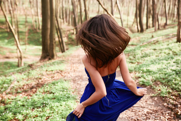 A beautiful girl enjoys a sunny forest