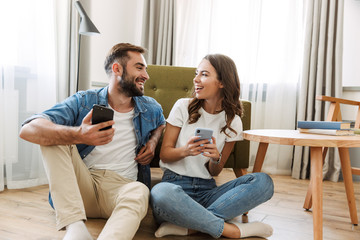 Beautiful young couple in love at home - Powered by Adobe