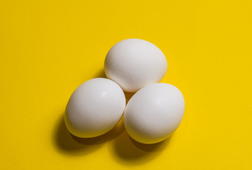 White eggs on a yellow background