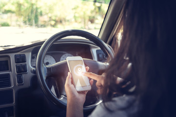 Car against businessman using a smartphone