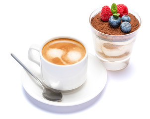 Cup of cofee and Classic tiramisu dessert with blueberries and raspberries in a glass isolated on a white background with clipping path