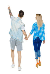 Back view of the couple walking and pointing upwards.