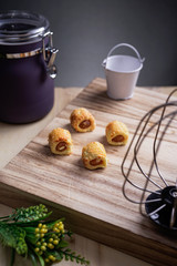 Pineapple tarts or nanas tart on wooden plate it is small bite size pastries filled with pineapple jam