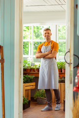Flower shop seller smiling to his customers.