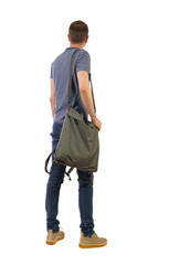 Naklejka premium Back view of a man with a green bag.