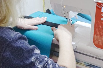 Fototapeta premium Seamstress at work on a sewing machine.