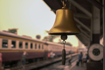 Gold Train station bell local in thailand with vintage train background.shallow focus effect.vintage tone.