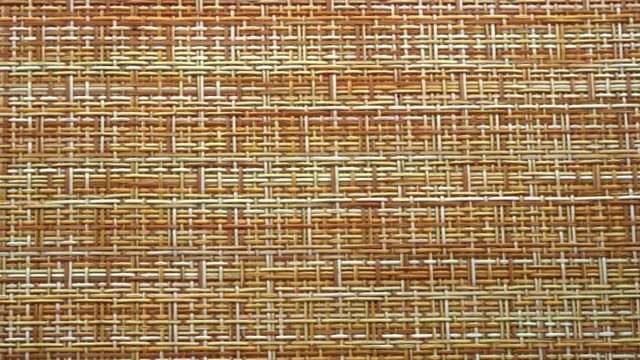 The texture of the fabric. Beige wicker fabric. Close-up. Can be used as a background.