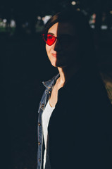 Portrait of young woman with shades on her face in red cat glasses