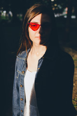 Portrait of young woman with shades on her face in red cat glasses