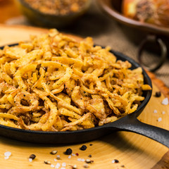 Crispy Fried Onion Strings with Garlic and Pepper. Selective focus.