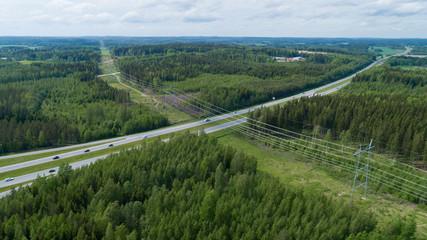 Fototapeta na wymiar Aerial view over the highway. Forest and power lines.