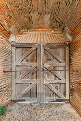Fototapeta na wymiar Brick wall and wooden gate