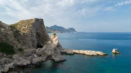 Fototapeta na wymiar Turquoise waters of mediterranean sea with cliffs. Rhodes, Greece.
