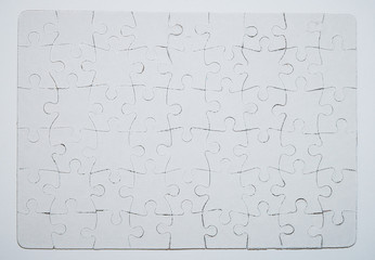 Blank white jigsaw puzzle pieces completed as copy space