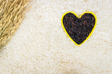 Heart shape of rice berry grains on white rice background; protects heart health and being good for the kidney, stomach and liver