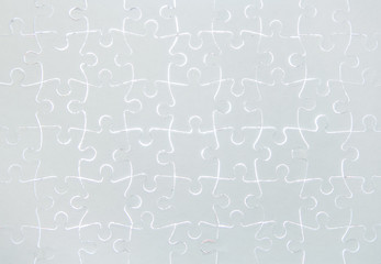 Blank white jigsaw puzzle pieces completed as copy space