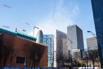 Modern architecture, sharp buildings. Vertical constructions, sky and Construction cranes landscapes. Poblenou area, barcelona