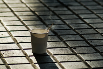 Fresh hot coffee on a pavement