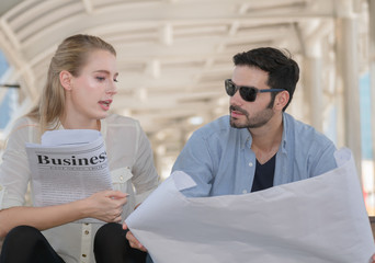 Fototapeta premium Business team reading newspaper .Happy couple reading newspaper for business concept.