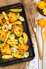 Roasted Chicken with Potatoes and Meyer Lemon. Selective focus.