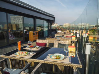 Sky cafe on the roof terrace with view of modern city