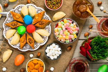 Colored eggs, wheat springs and sweet pastry for Novruz Holiday in Azerbaijan. Selective focus.