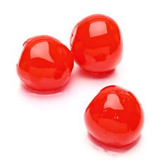 Maraschino cherries with syrup isolated on white background