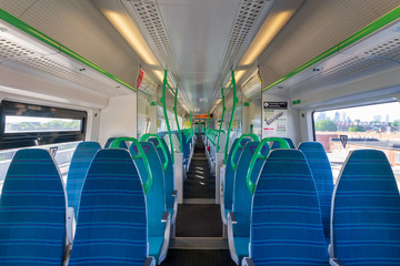 Fototapeta premium White light panoramic view interior of a high speed electric modern train with blue seats