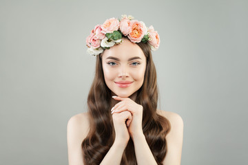 Young beautiful woman portrait. Pretty model girl with clear skin, long hairstyle and flowers