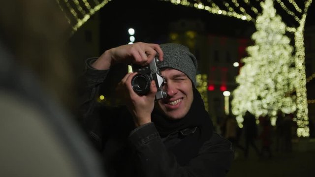 Man taking pictures on a winter night