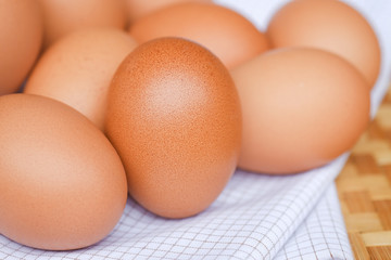 Brown eggs lay on a white plaid fabric. Food concept for weight loss.
