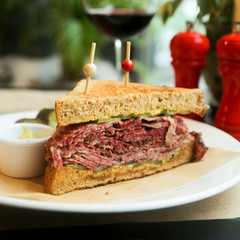 Pastrami sandwich with mustard and red wine