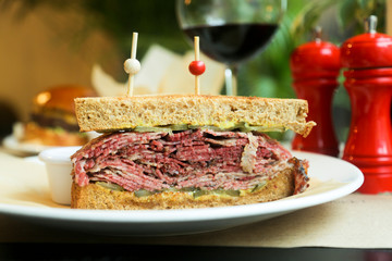 Pastrami sandwich with mustard and red wine