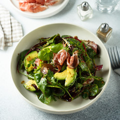 Healthy green salad with ham and avocado