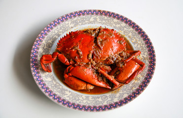 Crab in Padang sauce or Padang crab (Indonesian: Kepiting saus Padang) on white background.