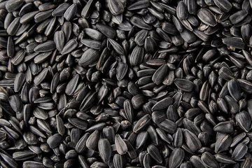 Rolgordijnen Black sunflower seeds. Black sunflower seeds for texture or background. Black sunflower seeds macro close up © Aliaksei