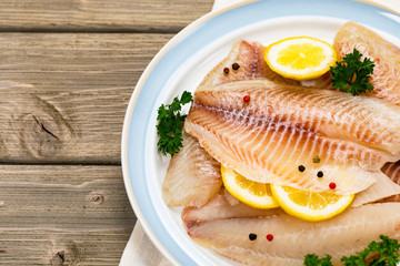 Whitefish Tilapia Fish Raw Fillet on Wooden Background. Selective focus.